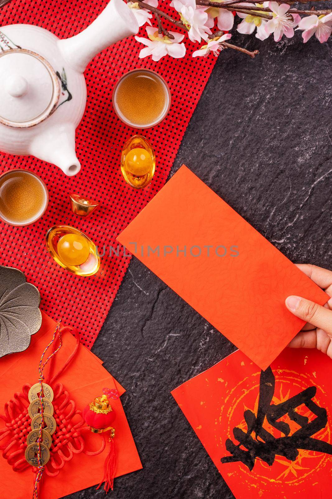 Design concept of Chinese lunar January new year - Woman holding, giving red envelopes (ang pow, hong bao) for lucky money, top view, flat lay, overhead above. The word 'chun' means coming spring.