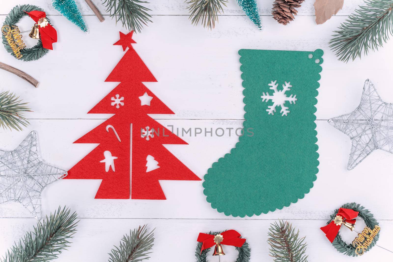 Christmas concept composition decoration objects, fir tree branch wreath and ornament isolated on white wooden table, top view, flat lay, layout up.