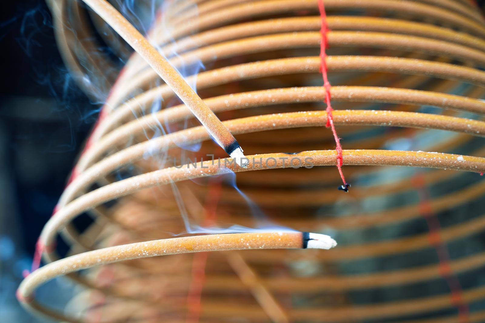 Burned coil swirl incense in Macau (Macao) temple, traditional Chinese cultural customs to worship god, close up, lifestyle.