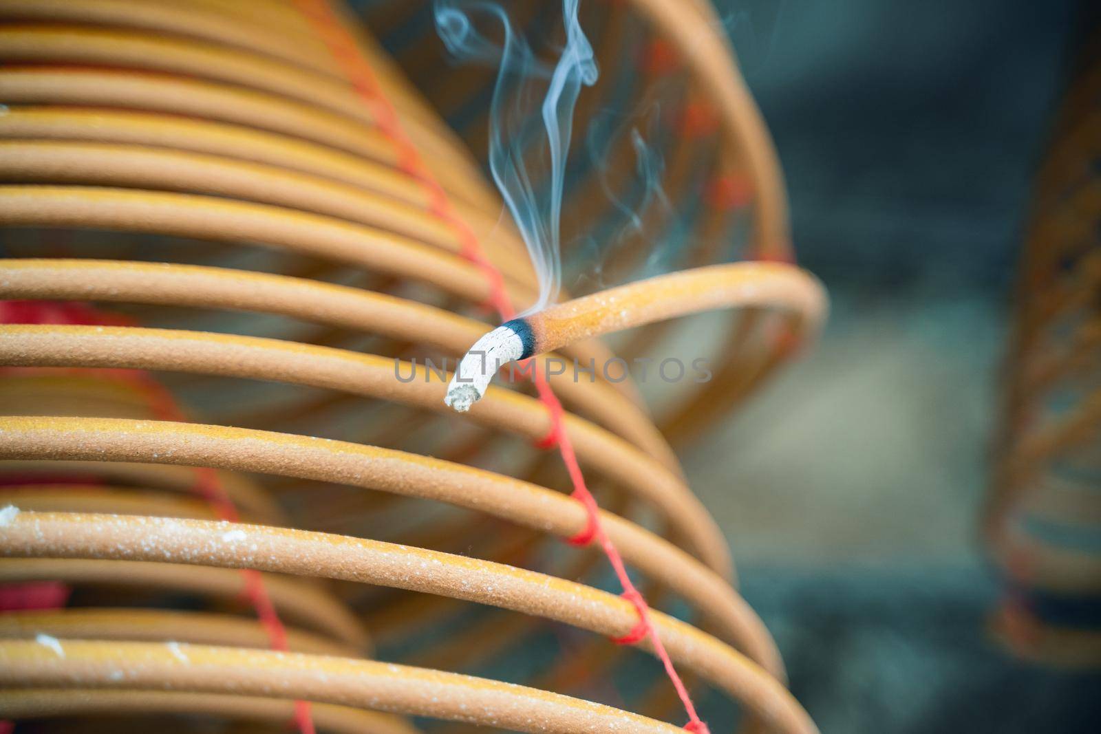 Burned coil swirl incense in Macau (Macao) temple, traditional Chinese cultural customs to worship god, close up, lifestyle.