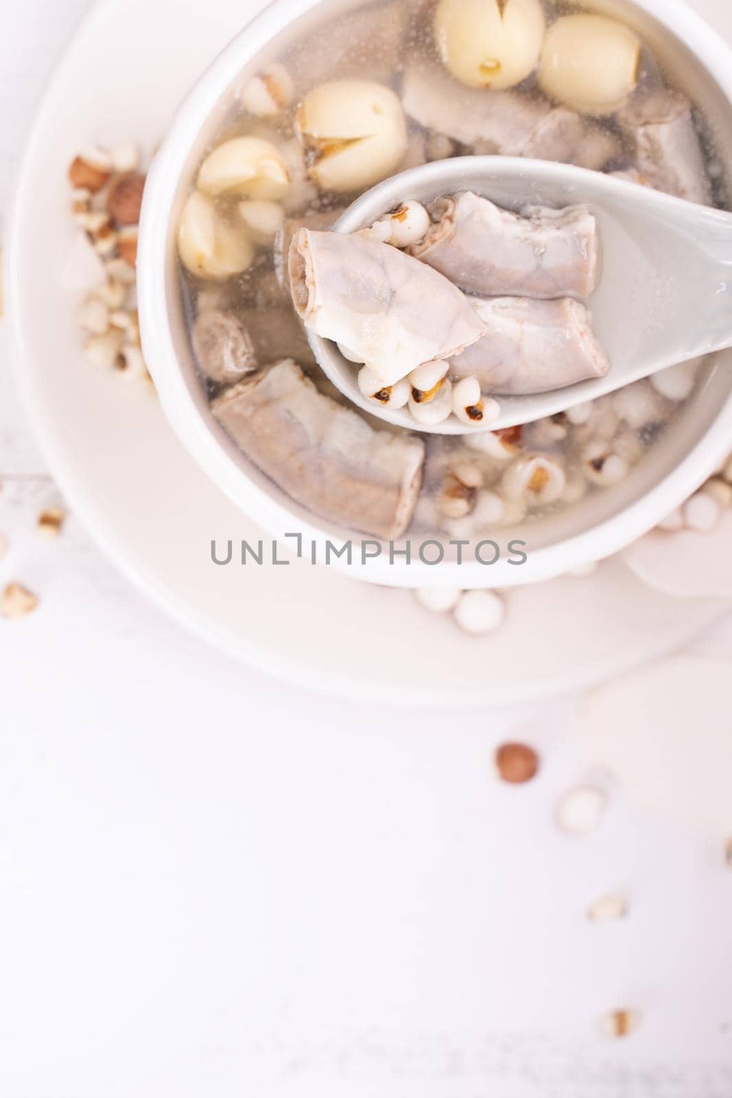 Tasty Four Tonics Herb Flavor Soup,Taiwanese traditional food with herbs,pork intestines on white wooden table,close up,flat lay,top view by ROMIXIMAGE