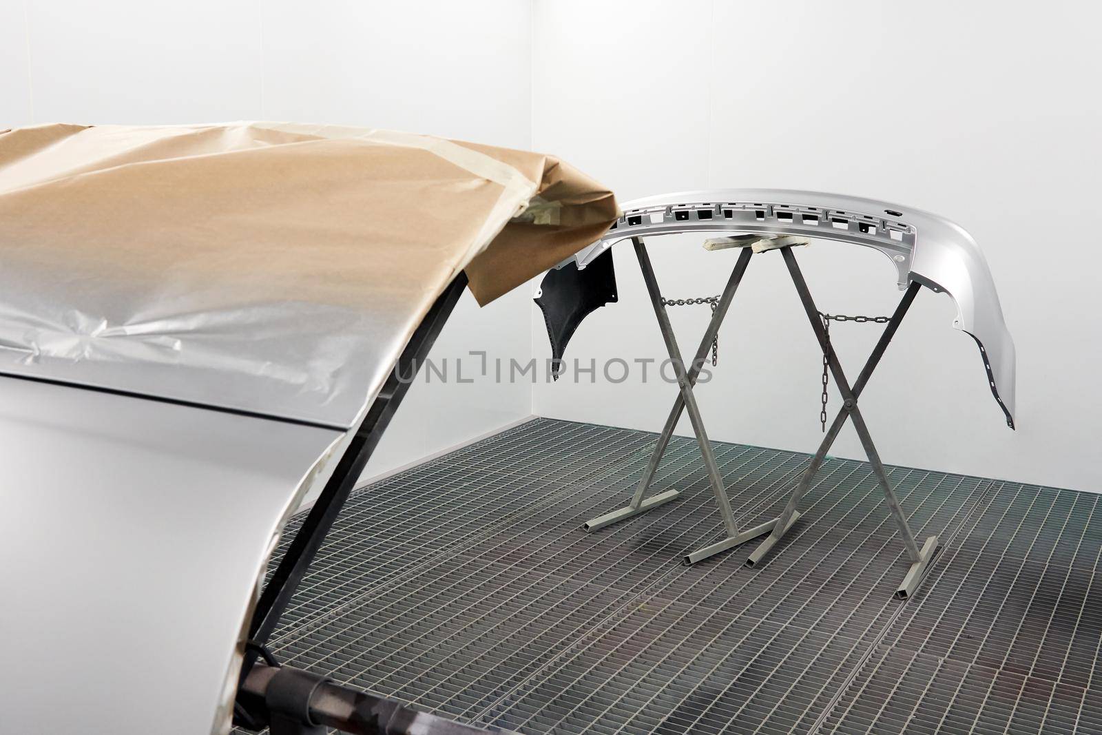 Painting And Drying In Professional Box Of Car Body Parts After Applying Putty And Paint On Bumper