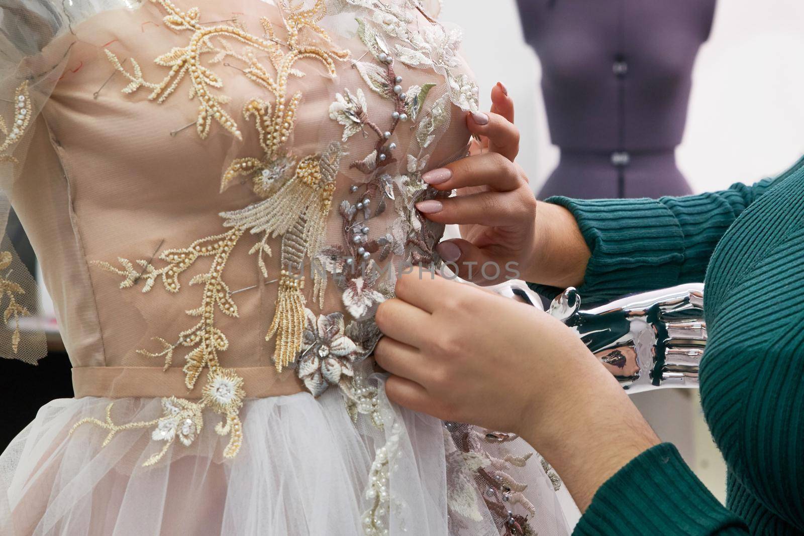 Beautiful white lace and silk wedding dress on a mannequin.