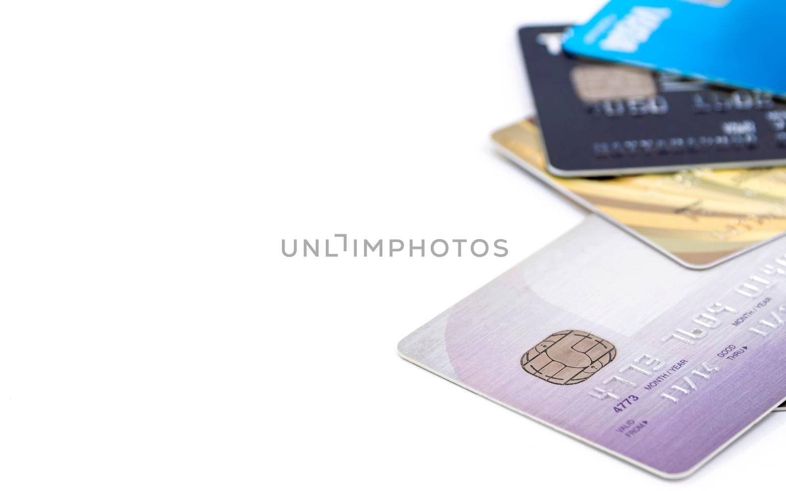 Selective focus of group of multi colored bank credit cards on white background. by wattanaphob