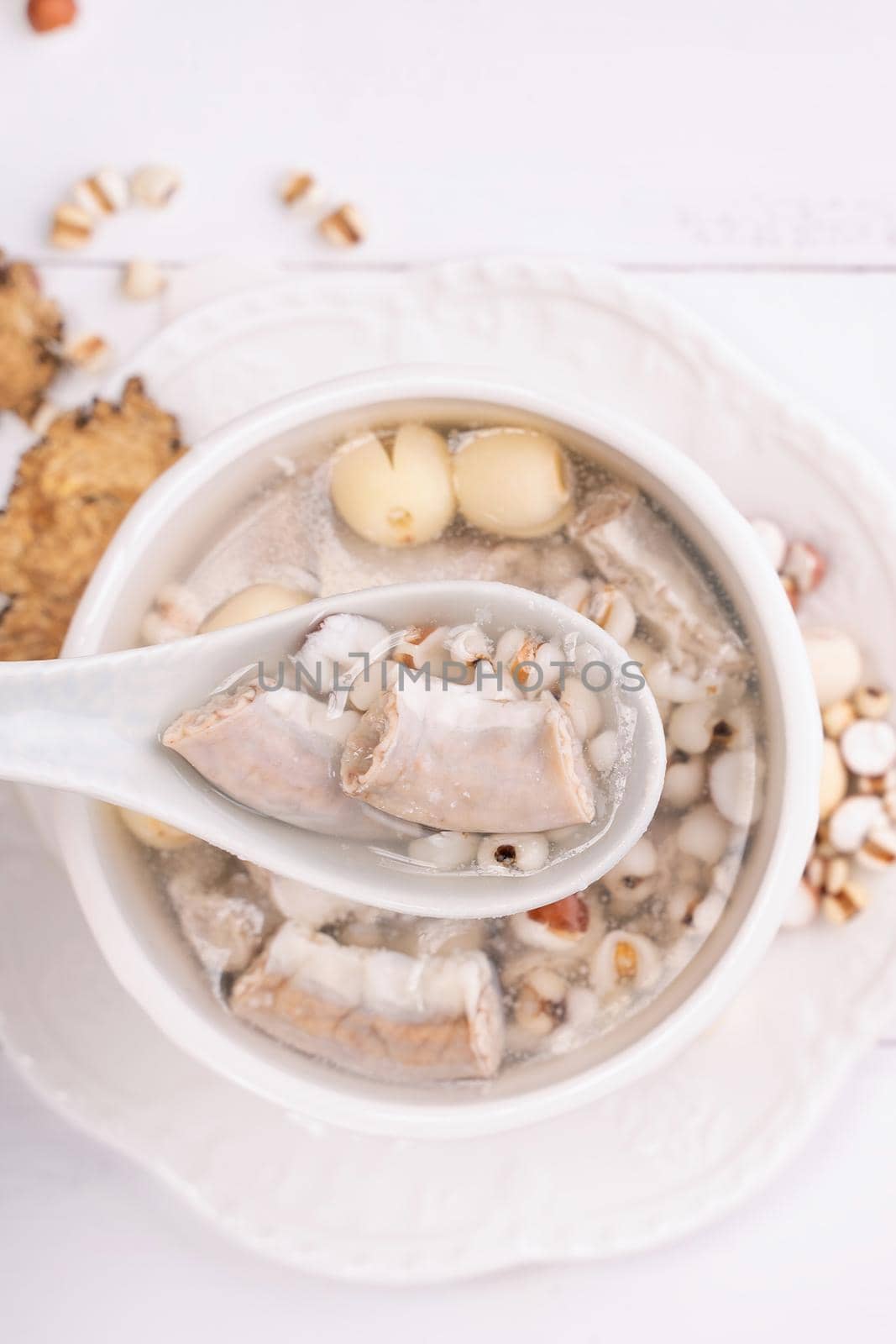 Tasty Four Tonics Herb Flavor Soup,Taiwanese traditional food with herbs,pork intestines on white wooden table,close up,flat lay,top view by ROMIXIMAGE