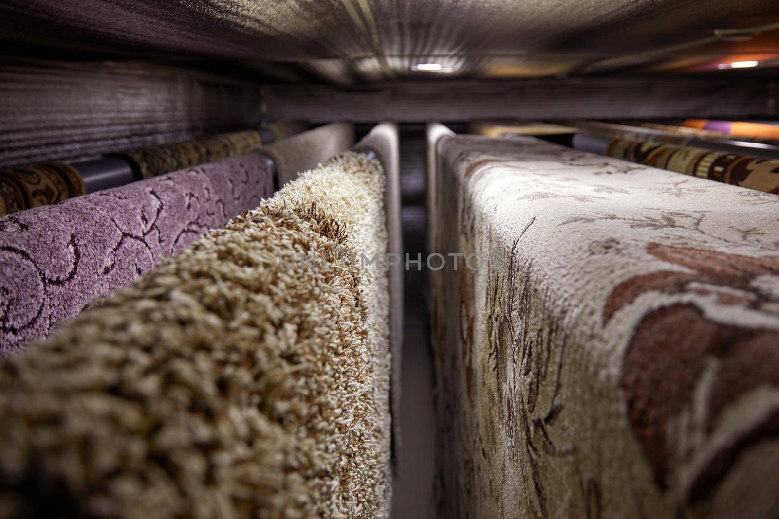 Different carpets hanging on racks. Professional carpet cleaning and drying.