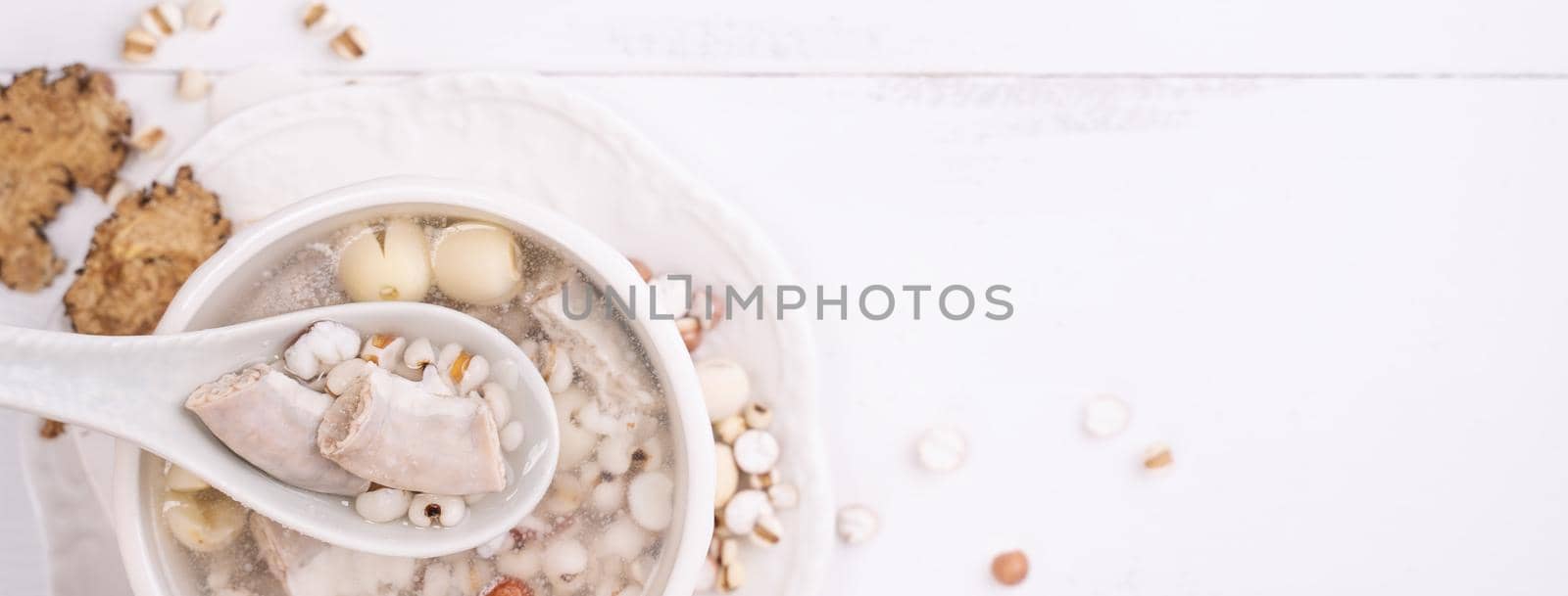 Tasty Four Tonics Herb Flavor Soup, Taiwanese traditional food with herbs, pork intestines on white wooden table, close up, flat lay, top view.