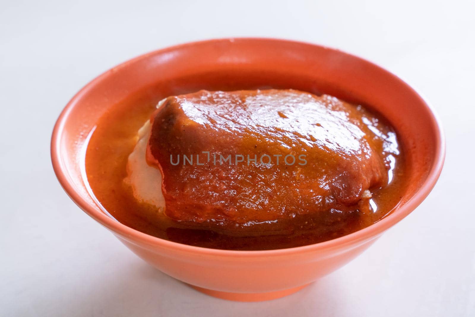 Tamsui agei (age, aburaage), delicious famous street food in Taipei, Taiwan, stuffed with mung bean noodles and chili sauce topping, lifestyle, close up.