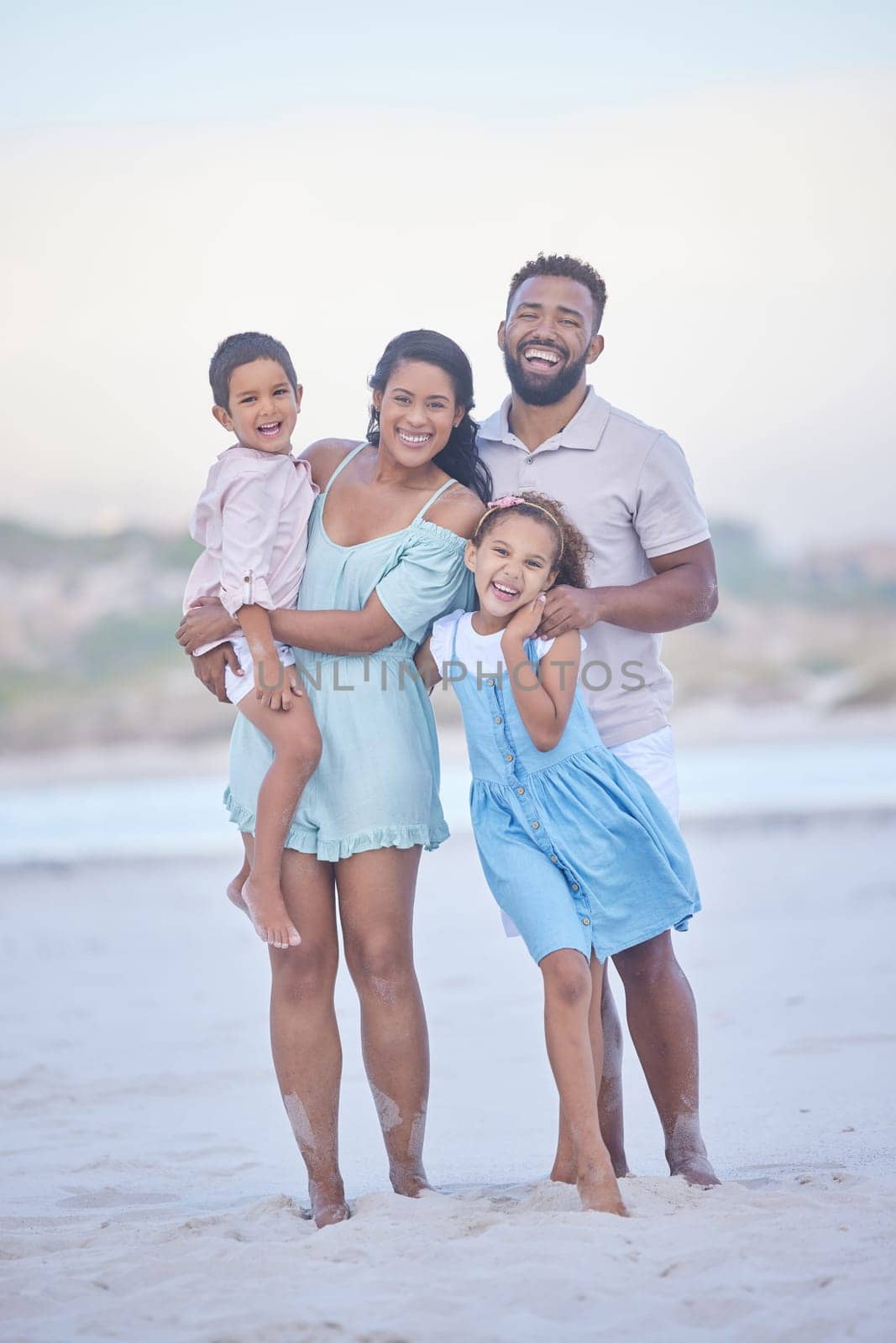 Family, parents or portrait of happy kids at sea to travel with joy, smile or love on holiday vacation. Mom, beach or father smiling with children in Mexico with happiness bonding or walking together.