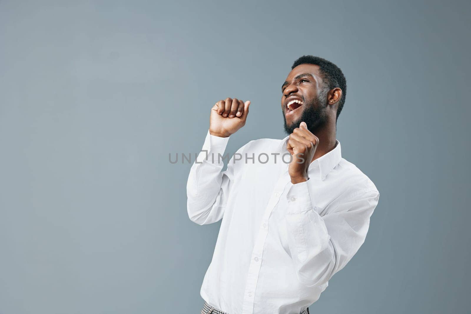 smiling man handsome advertising copy cheerful business studio guy smile african confident young space advertisement positive happy happiness white shirt american american standing