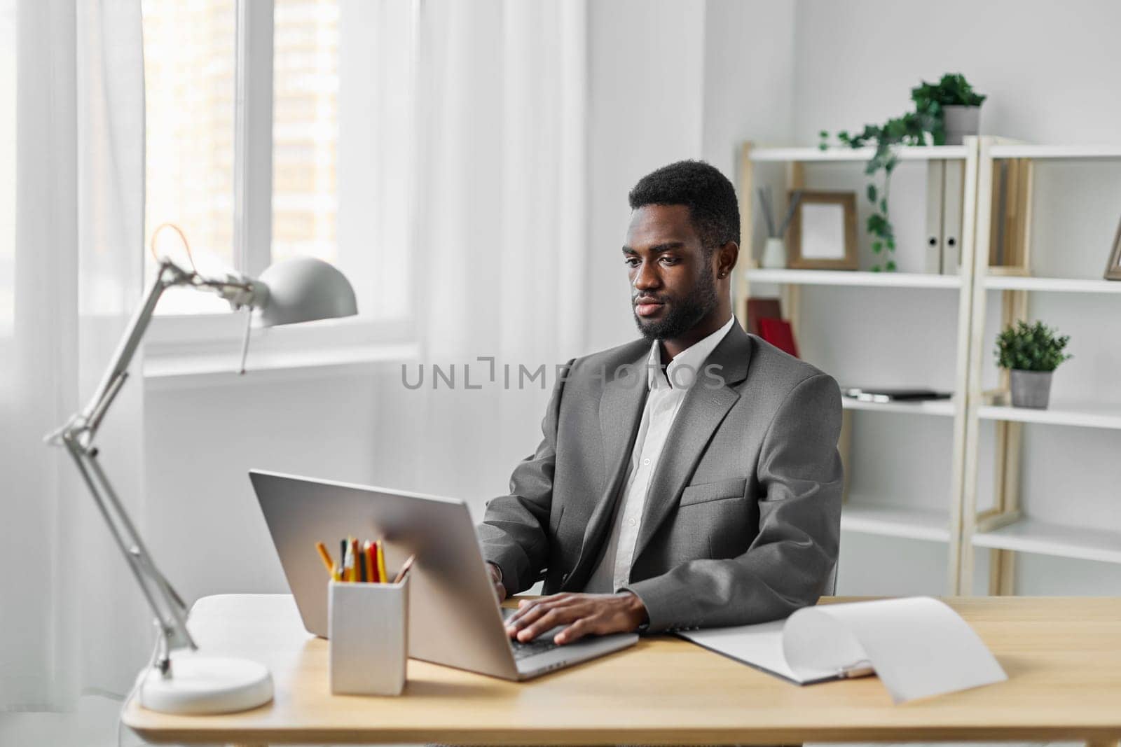 man worker freelancer african call corporate student male computer using american office job online distance freelance business black web education table laptop