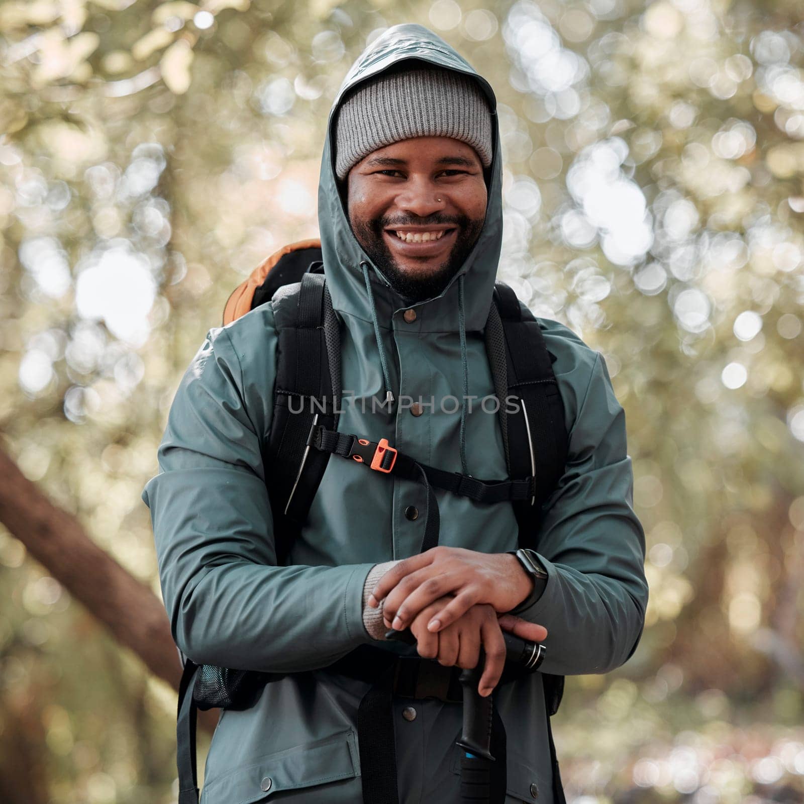 Black man, portrait smile and hiking in nature for travel, adventure and journey in the outdoors. Happy African male person or hiker smiling in trekking, walk or hike for fitness, workout or exercise by YuriArcurs