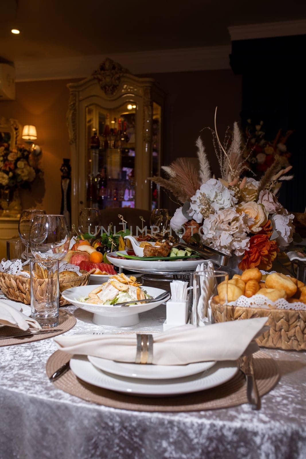 decorated table with white dishes and napkins with various dishes. festive table in the restaurant.