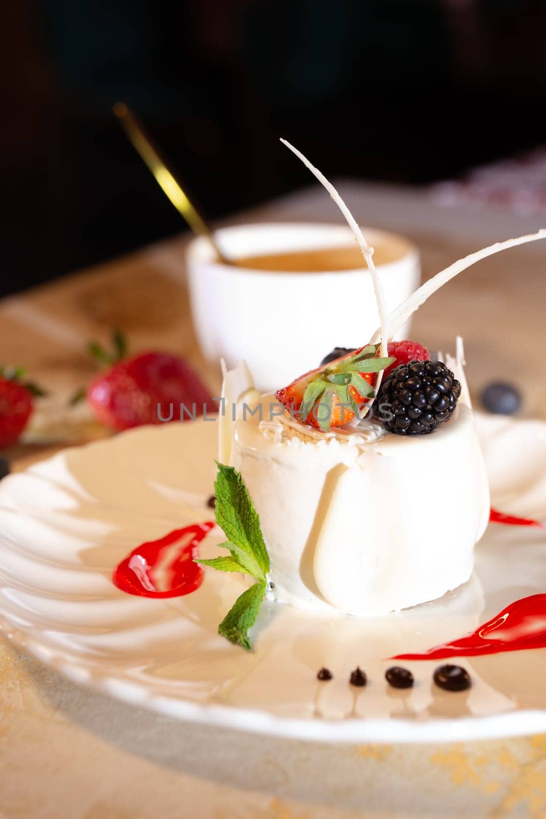 a beautiful fresh white dessert in a restaurant on the table. original dessert serving.