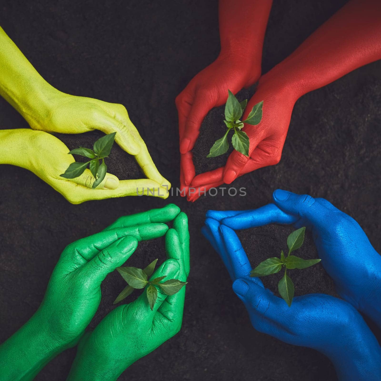 Nature will be proud. unrecognizable people holding budding plants in their multi colored hands. by YuriArcurs