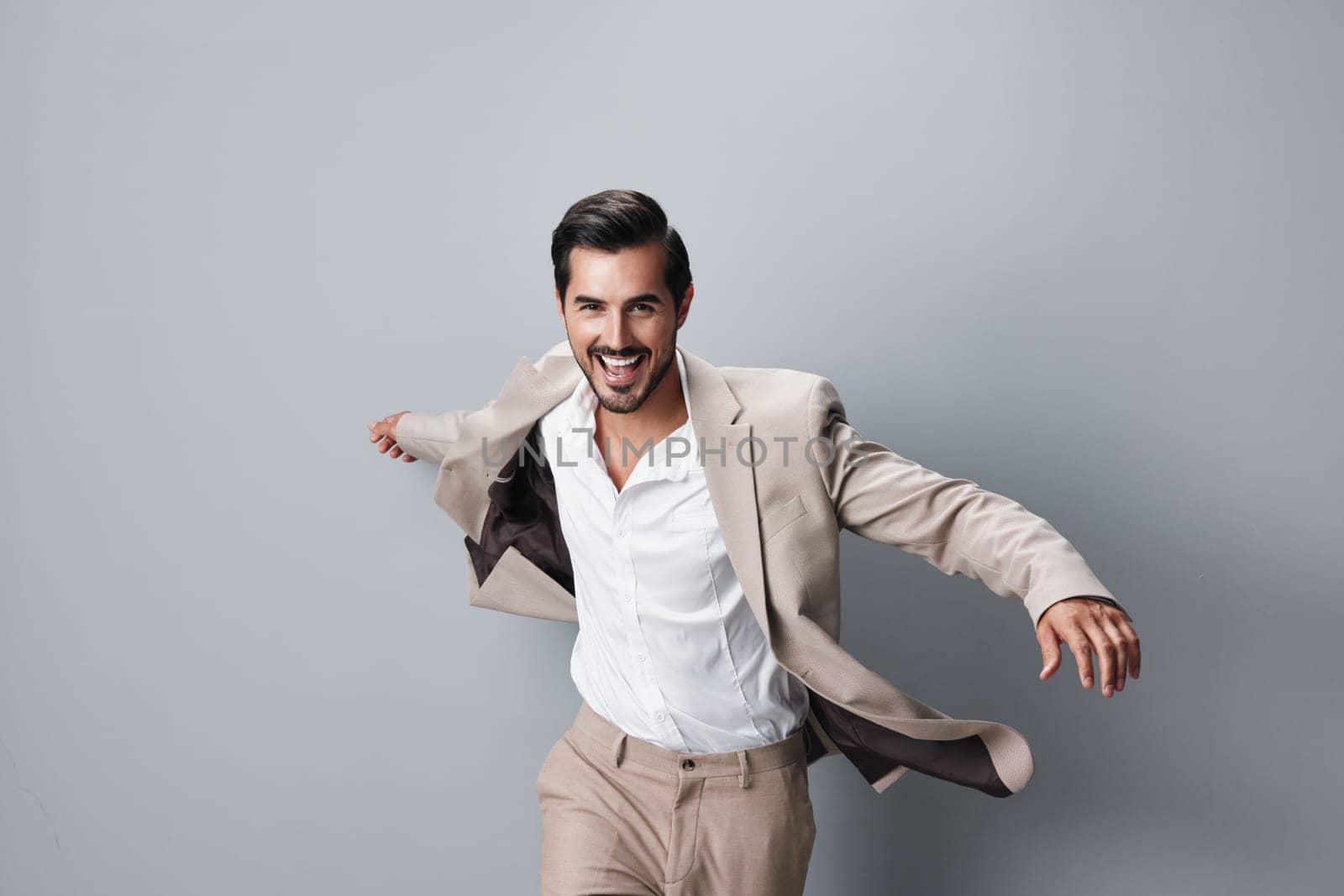 man background flying jacket winner business occupation businessman happy beard tie arm hand flying studio success running suit confident victory beige cheerful