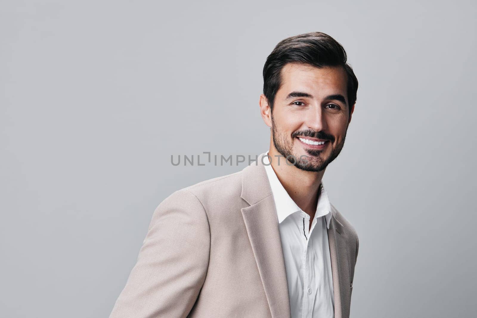 copyspace man portrait happy handsome smiling businessman stylish business beige suit by SHOTPRIME