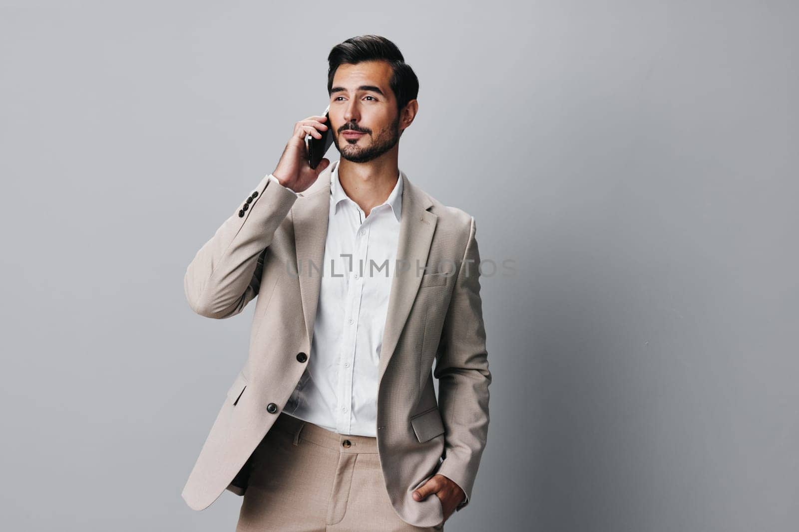 suit man portrait beige smile call hold business happy phone smartphone by SHOTPRIME