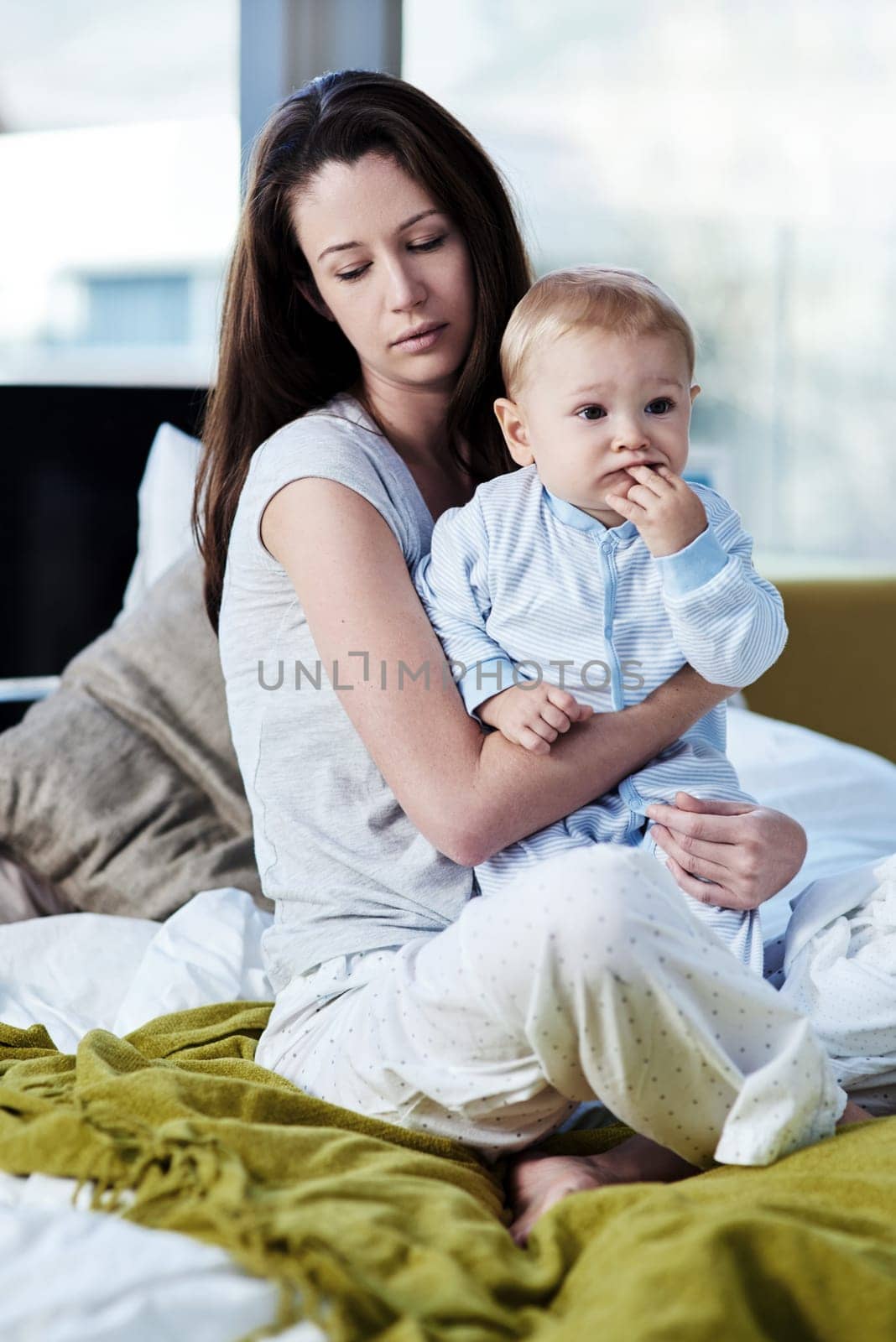 Baby, mother and sad with postpartum on bed at family house and problem with stress or being tired. Mom, newborn and depression with mental health at home with insomnia about child development