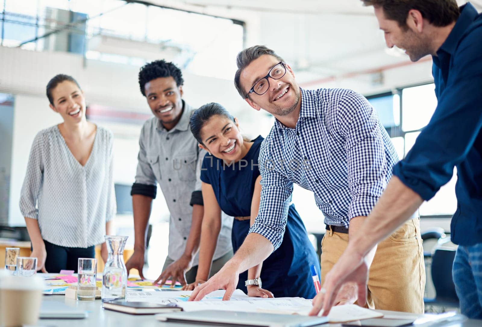 Group, creative and staff in a meeting, brainstorming and planning with ideas, conversation and teamwork. Male person, leader or happy team with collaboration, partnership and growth with development.