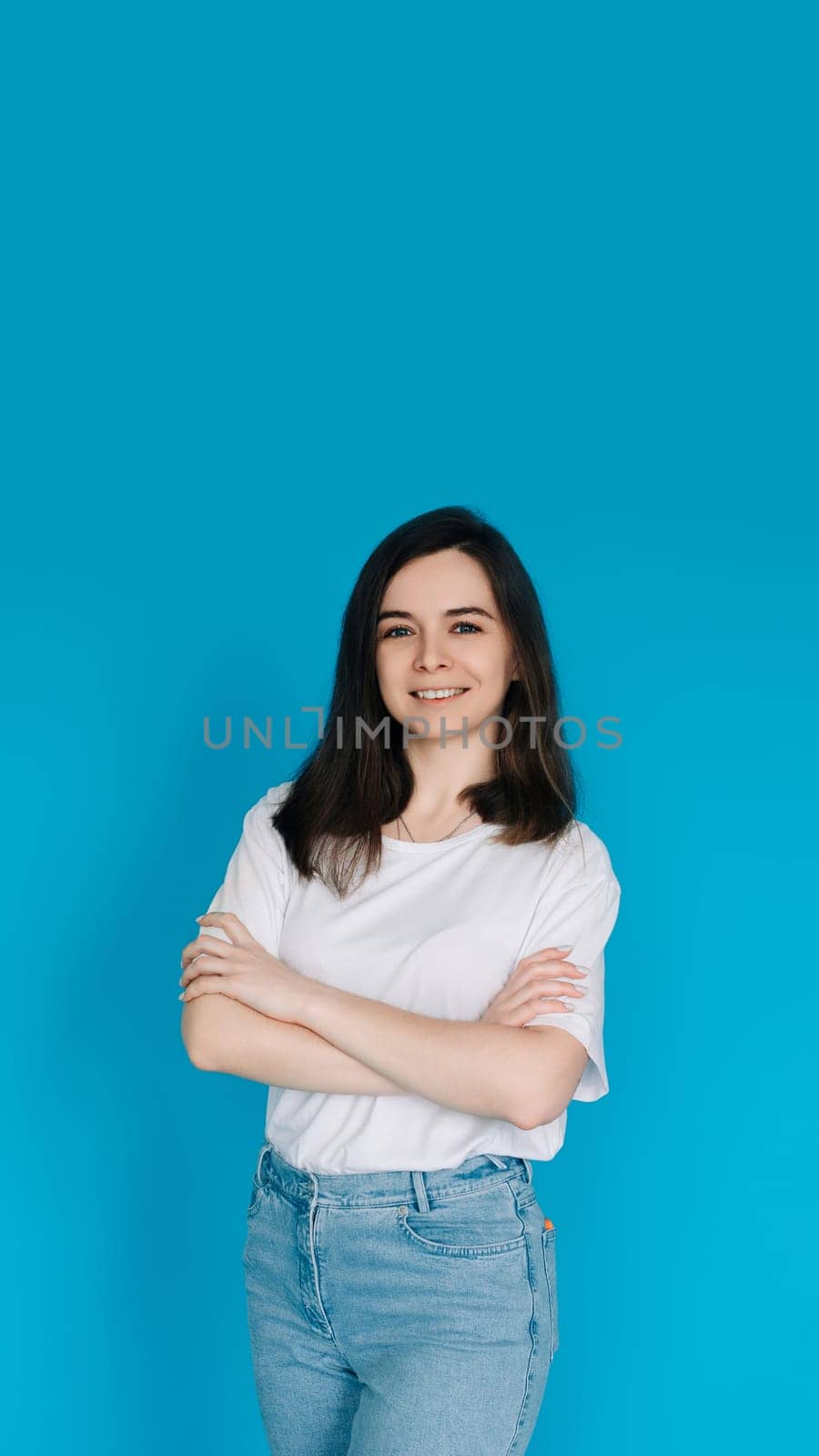 Successful Businesswoman in Casual Attire - Confident Female Office Manager with Crossed Arms - Isolated on Blue Background - Ideal for Corporate, Career, and Professional Concepts.