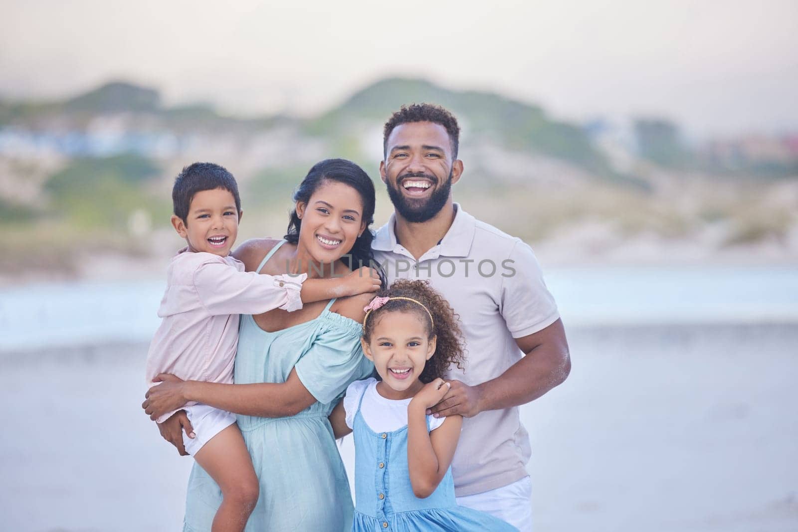 Family, parents or portrait of happy kids on beach to travel with joy, smile or love on holiday vacation. Mom, siblings or father with children for tourism in Mexico with happiness bonding together.