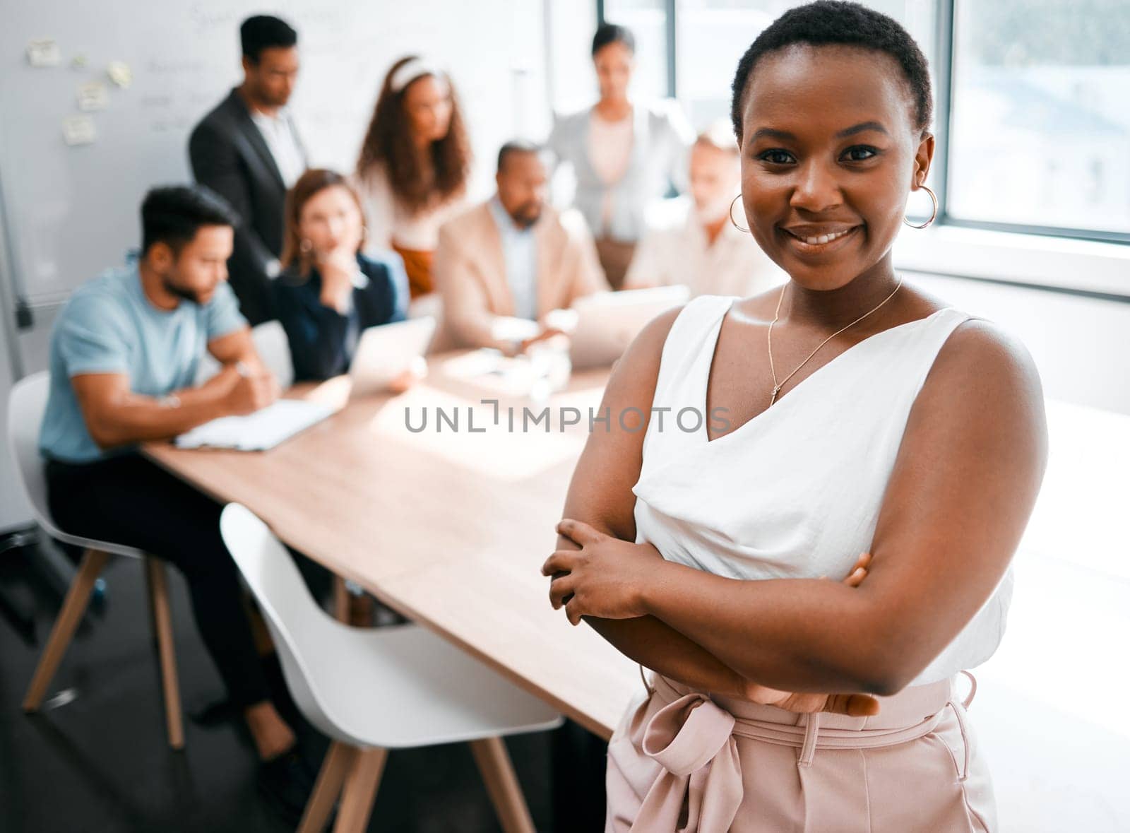 Black woman in business, smile in portrait and arms crossed, leadership and meeting with company group. Team leader, manager and confidence with female person in conference room and professional.