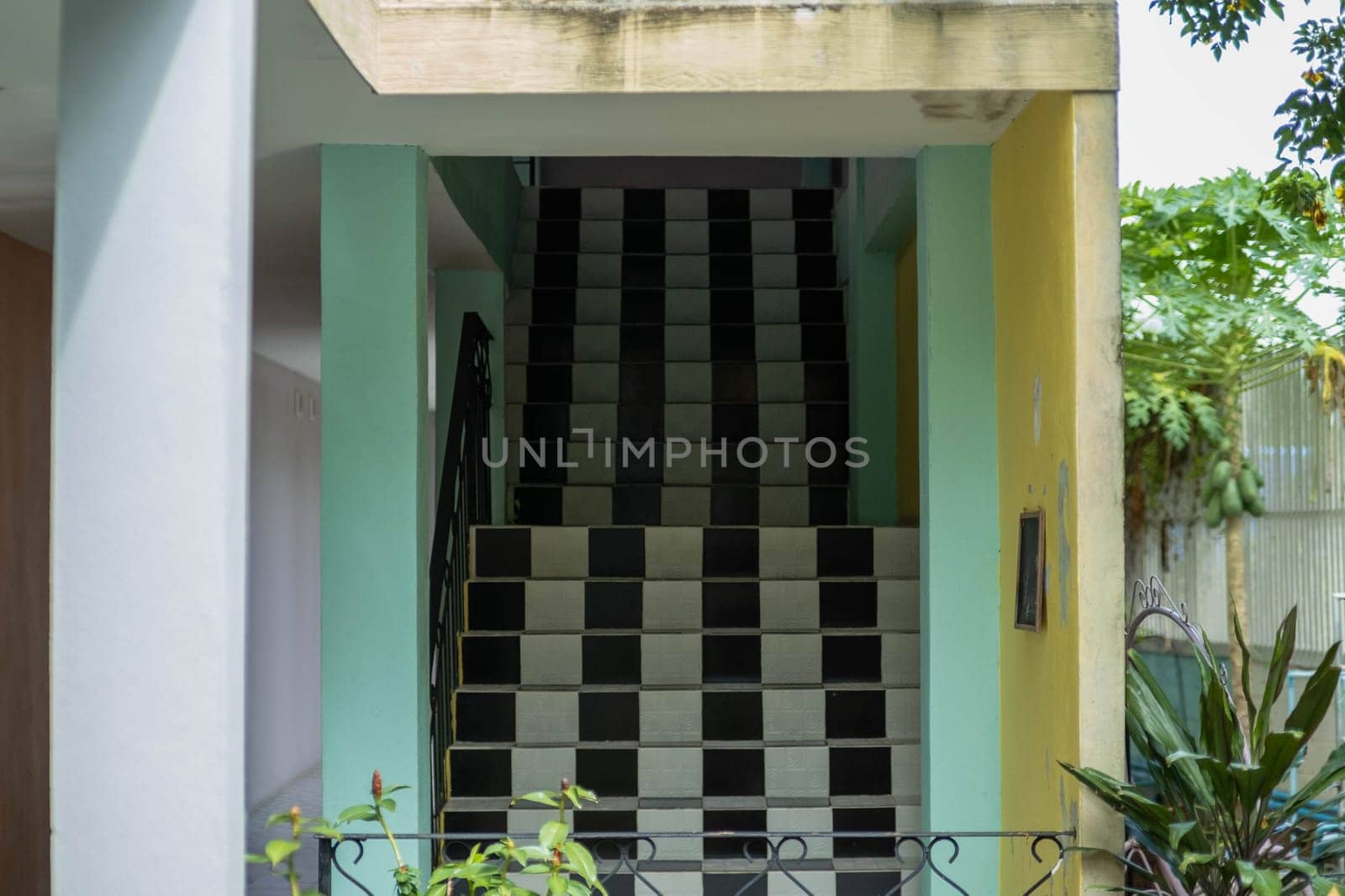 Long black and white tiled staircase in the building. building entrance stairs by TEERASAK