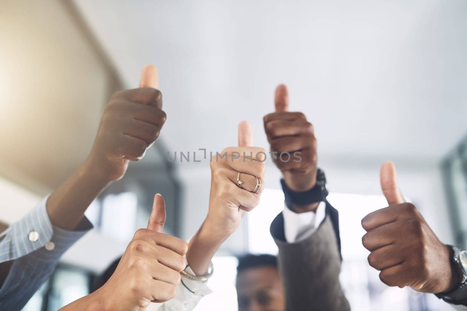 Your talents are amazing. Closeup shot of a group of businesspeople showing thumbs up in an office. by YuriArcurs