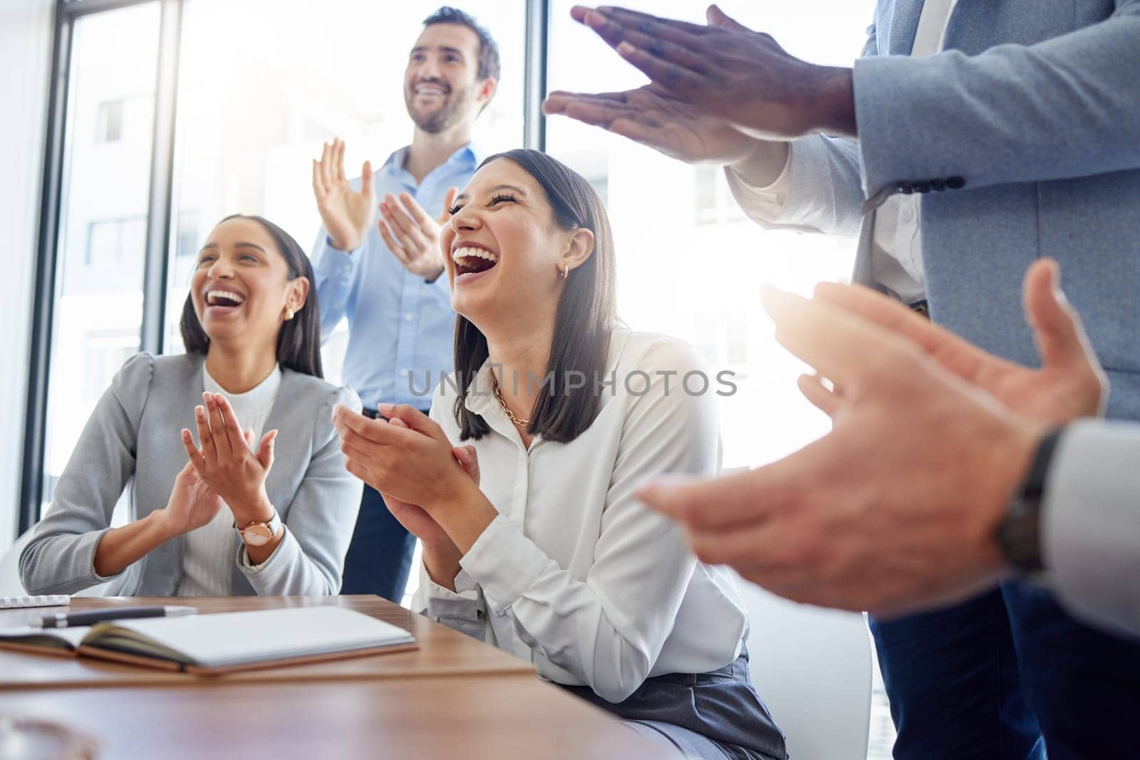 Motivation, audience with an applause and in a business meeting at work with a lens flare together. Support or celebration, success and colleagues clapping hands for good news or achievement.