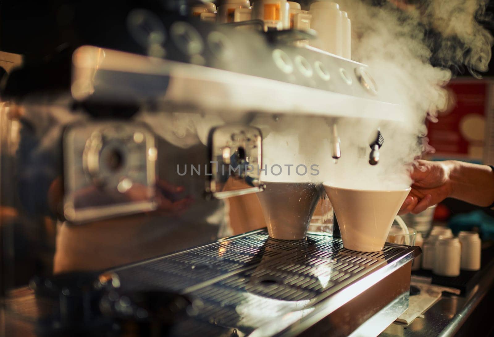 Coffee machine, steam and hands of cafe person, barista or diner waiter making beverage, latte drink or espresso. Tea cup, commerce market shop and restaurant store server with morning hot chocolate.