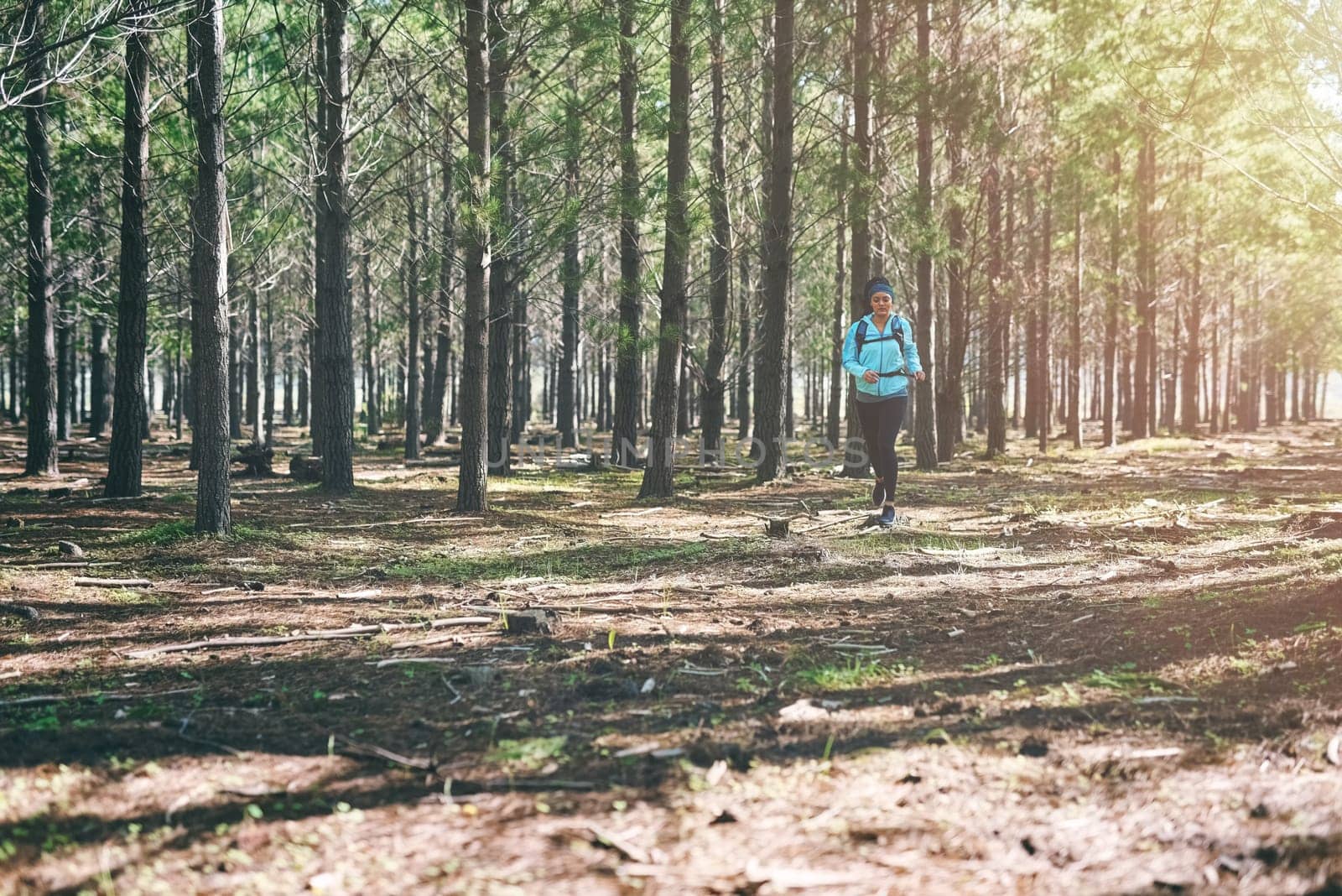 Fitness is about being better than you were yesterday. Full length shot of an athletic young woman out for a jog in the woods