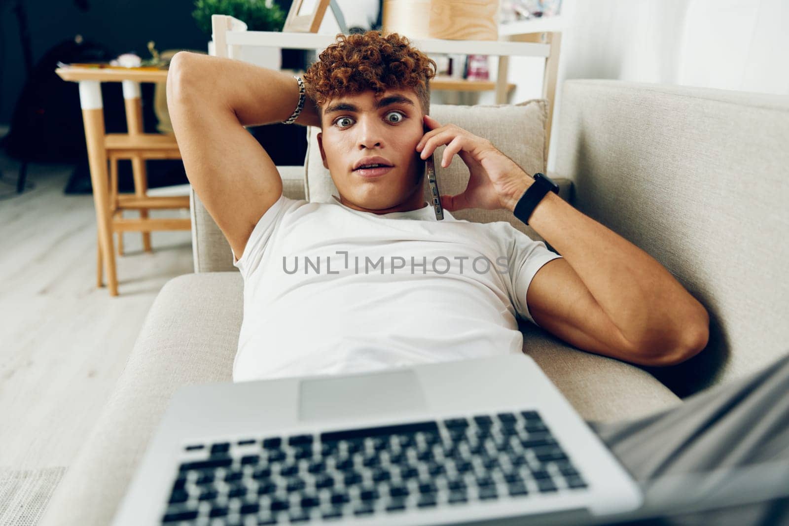 man interior room indoor t-shirt internet online laptop male looking education computer typing freelance using caucasian