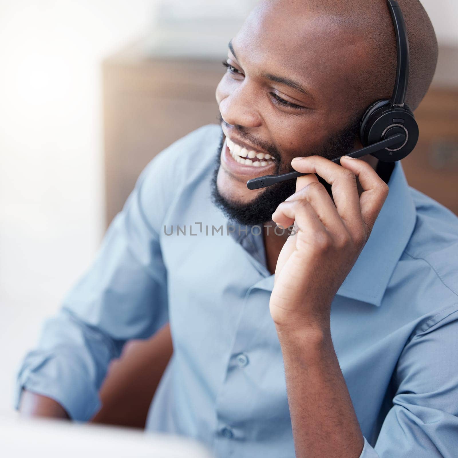 Black man, call center and happy agent working on computer in the office, business in telemarketing or customer service. Businessman, face with smile and crm, conversation with client on help desk.
