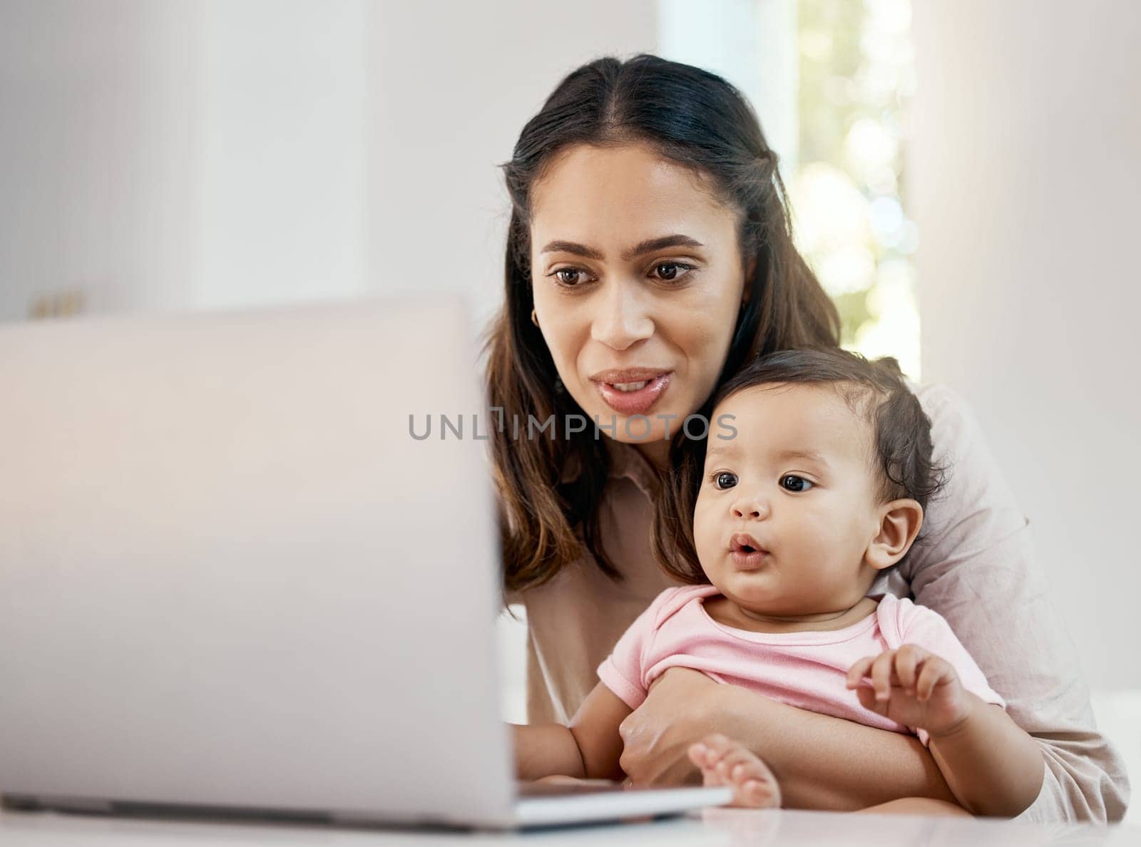 Smile, remote work and mother with baby and laptop, happy freelancer worker with online project in apartment. Working at home, woman and kid girl with happiness, internet and virtual job in kitchen