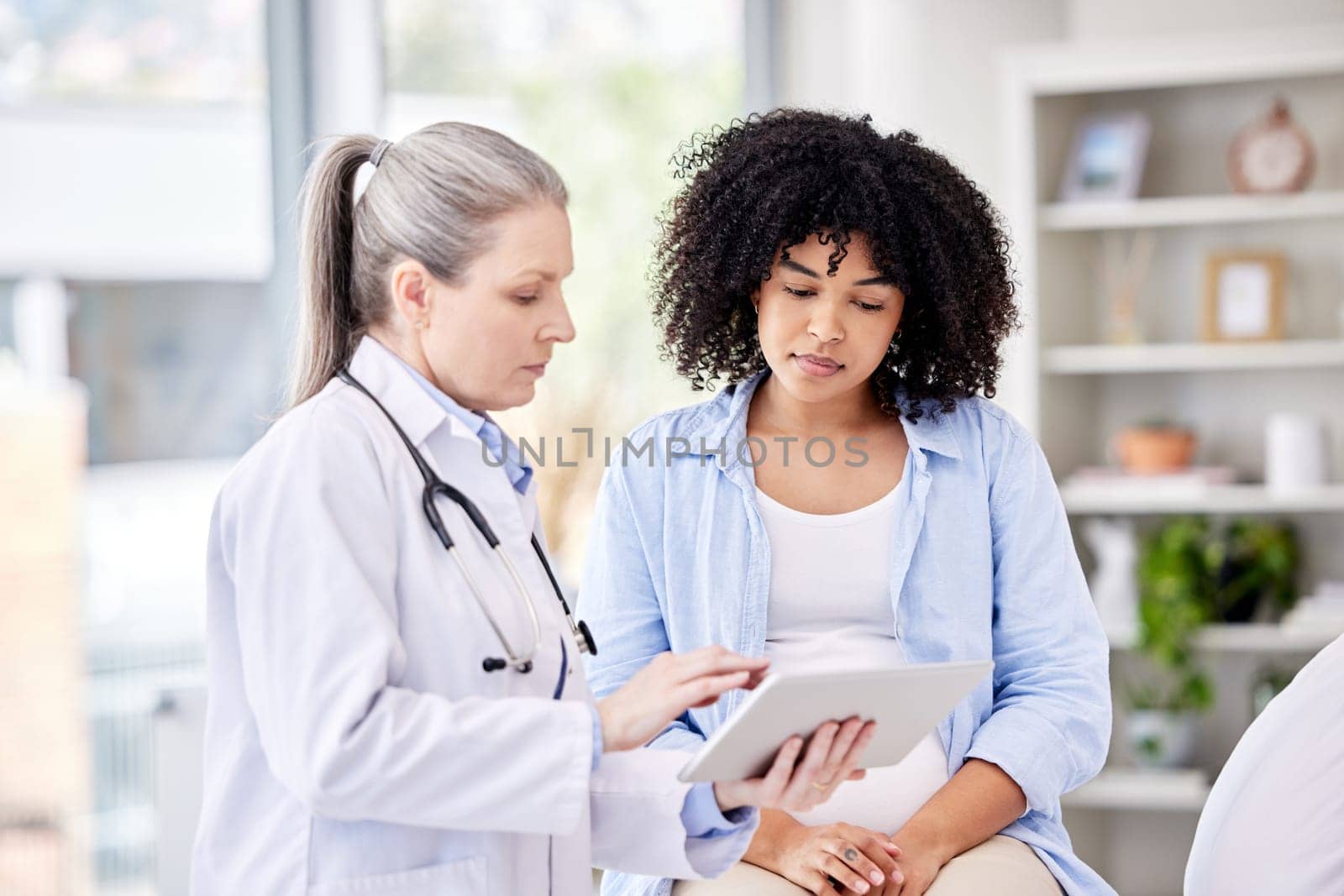Pregnant woman, doctor and tablet for healthcare results, gynecology service and serious news, exam or progress. Medical, gynecologist or people for pregnancy, digital technology and growth check.