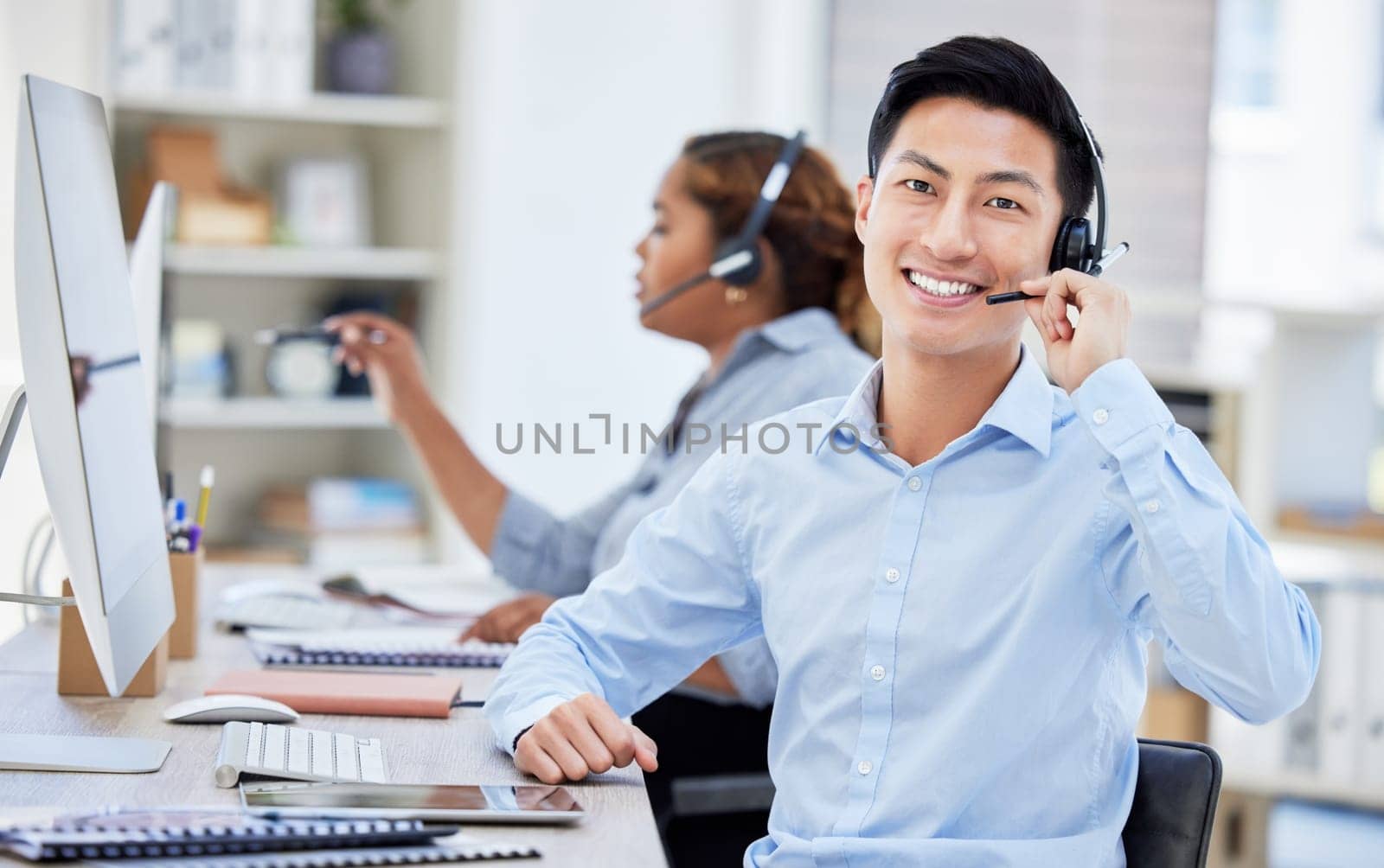 Portrait, call center and Asian man smile for customer service, telemarketing or tech support. Face, crm and sales agent, consultant or employee coworking at help desk, business office and consulting.