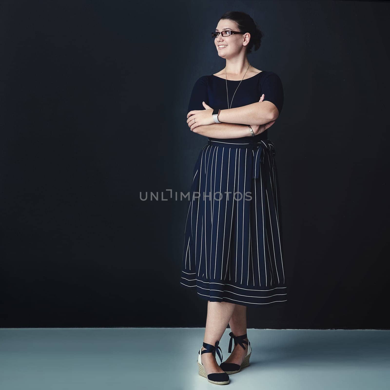 Never cease to dream big. Studio shot of a corporate businesswoman looking thoughtful against a dark background