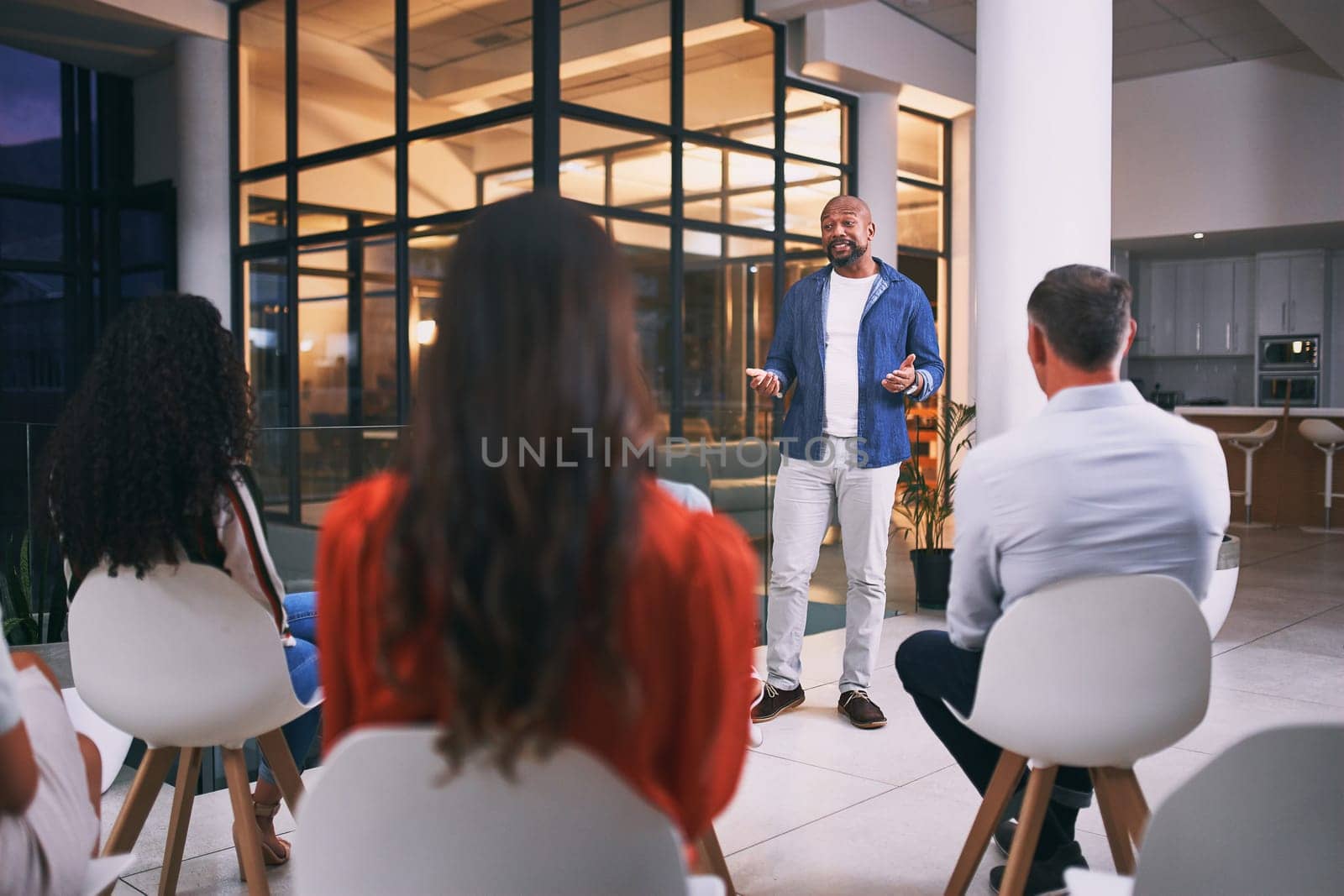 Hes got all the knowledge they need. a group of businesspeople attending a conference at work