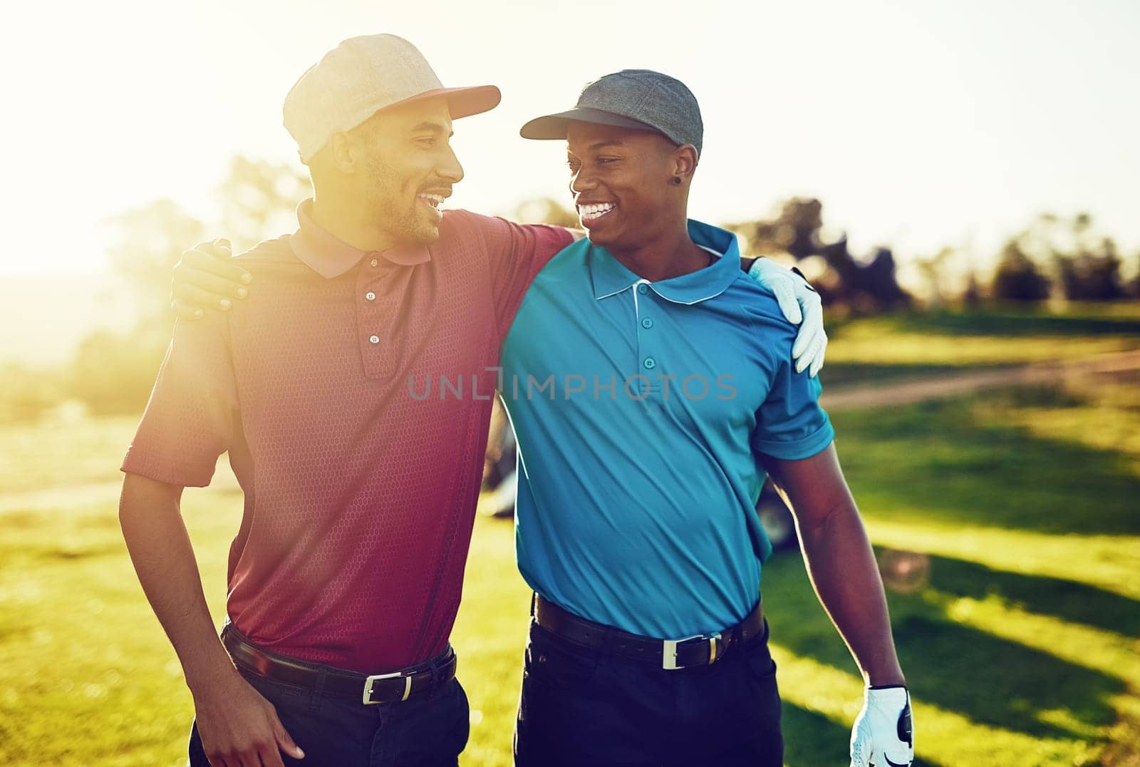To find a mans true character, play golf with him. two friends standing together on a golf course. by YuriArcurs