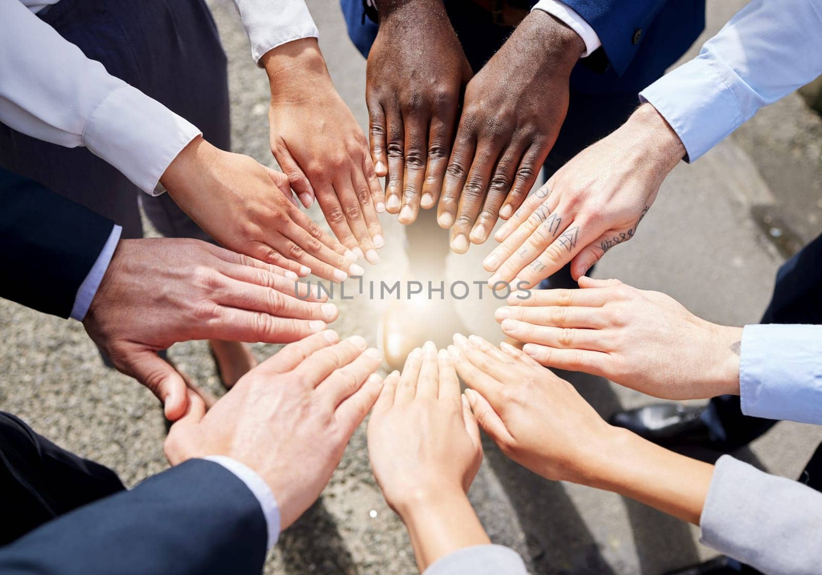 Hands, teamwork or top view of business people outside in collaboration for mission goals in city. Light, link or employees meeting with strategy, teamwork or support outdoors together in huddle.