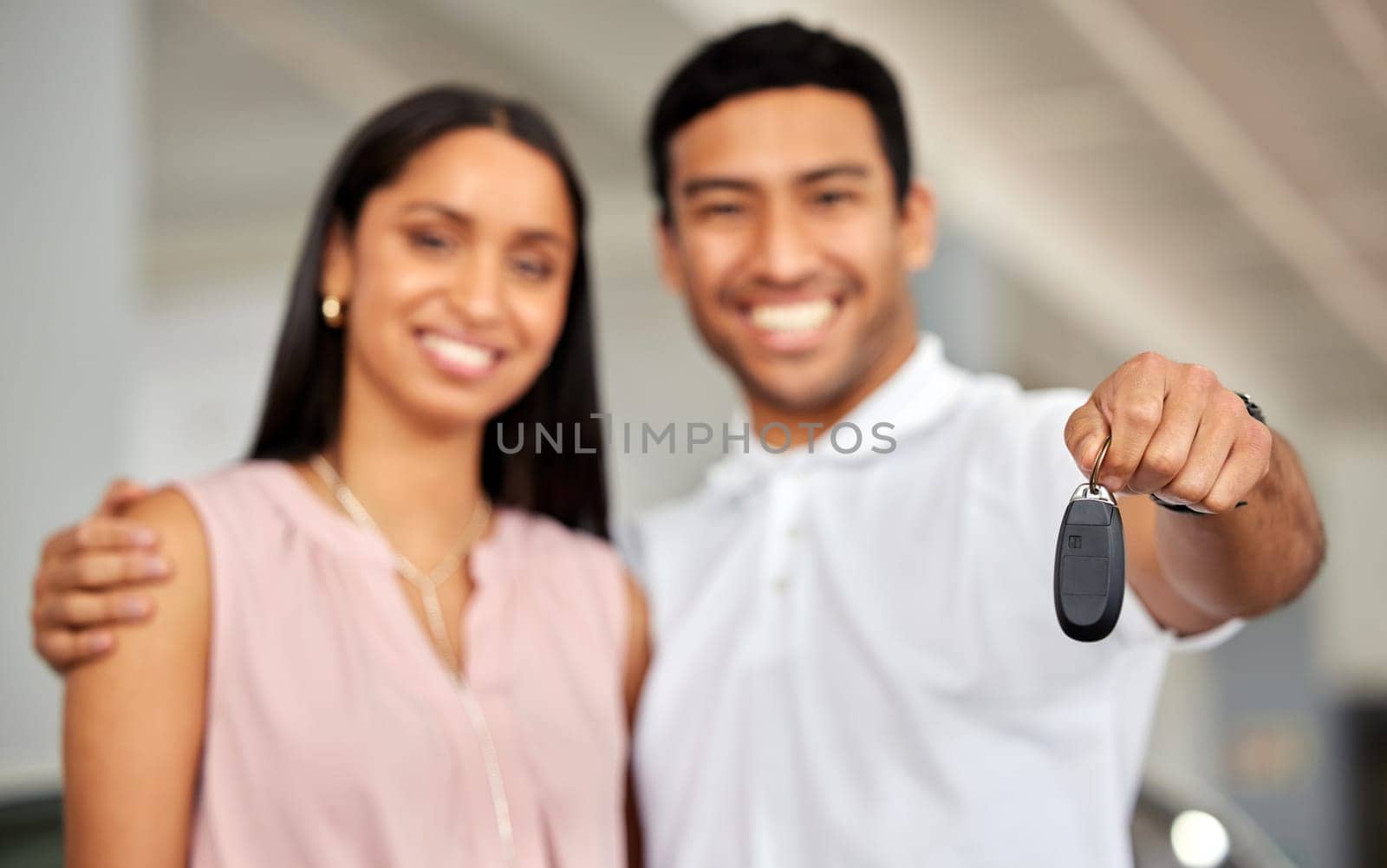 Couple at car dealership, choice and key in hand with transportation, buying new vehicle with luxury and smile. Happy with decision, man and woman at automobile showroom with purchase and cars by YuriArcurs