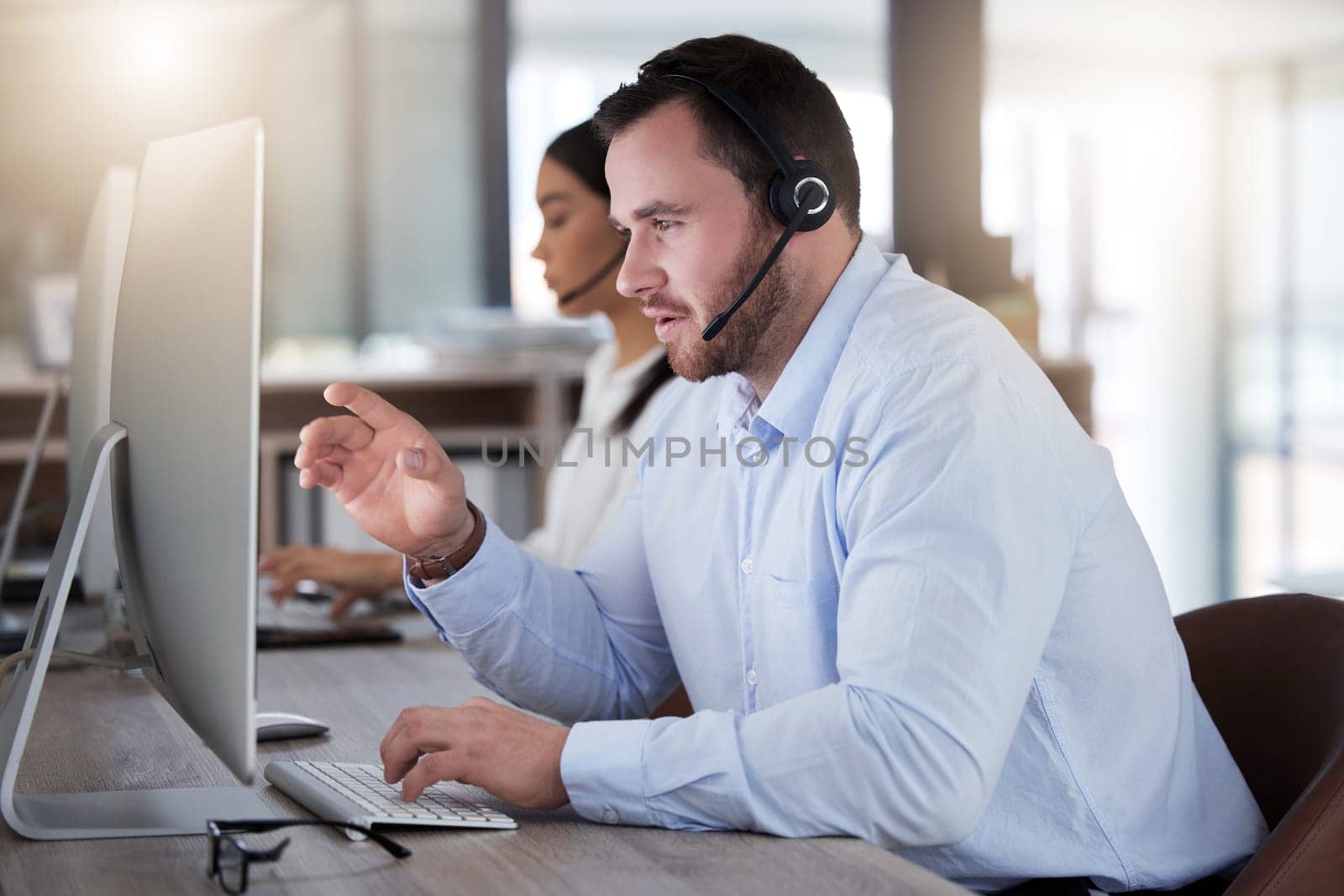 Call center, consulting and computer with man in office for communication, customer service or help desk. Telemarketing, sales and advice with male employee for commitment, contact us and hotline.