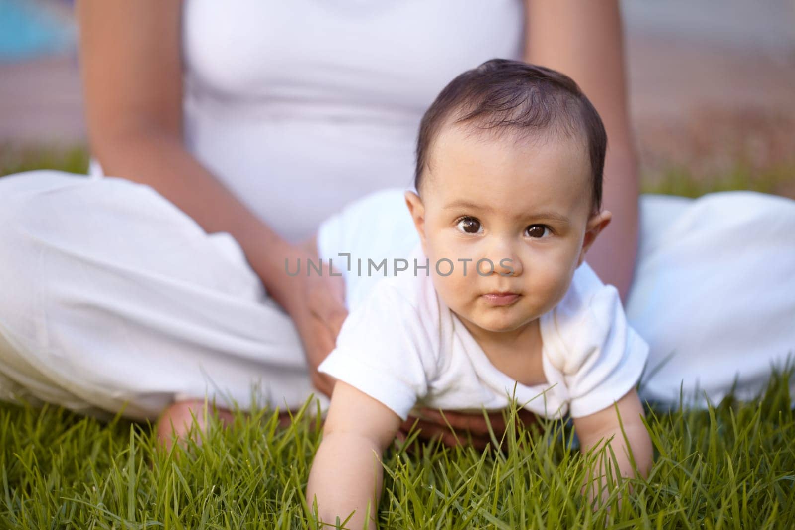 Portrait, crawling and baby with a mother in the park together during summer for bonding, care and playing. Kids, face and a curious infant child with mama on grass, garden and in nature outdoor.