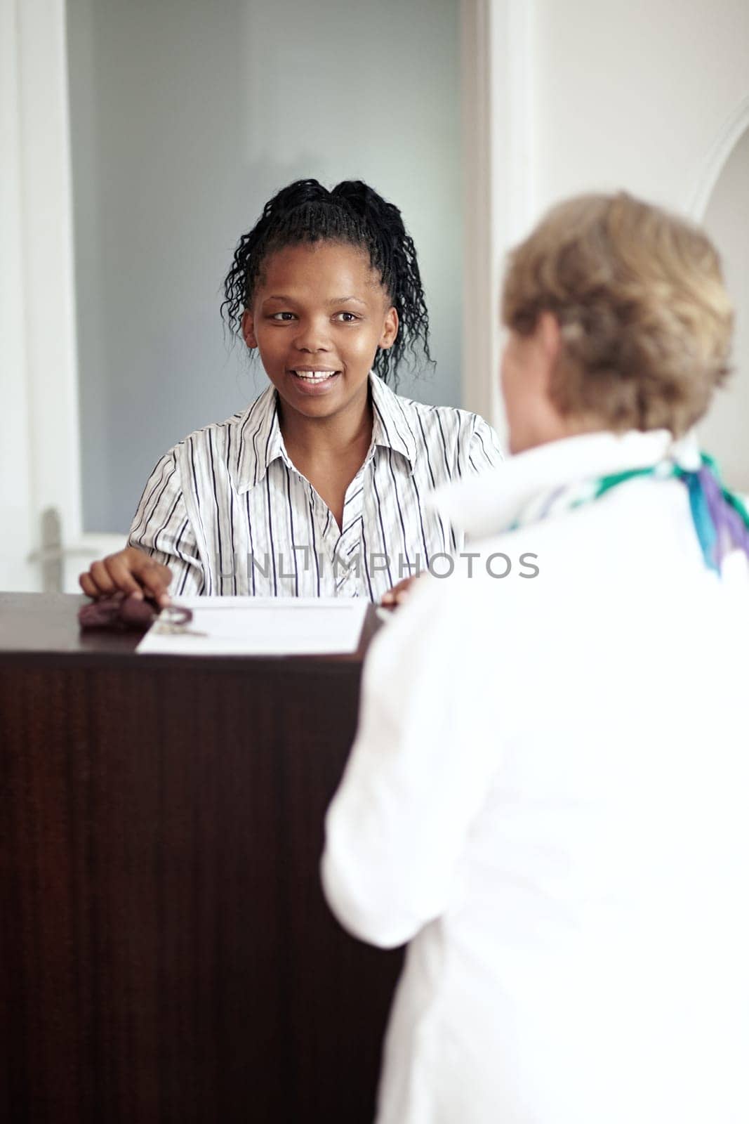 Hotel receptionist, hospitality and a black woman helping a senior tourist to check in at a luxury resort. Concierge, travel or holiday getaway with a happy female secretary in a lodge for assistance.