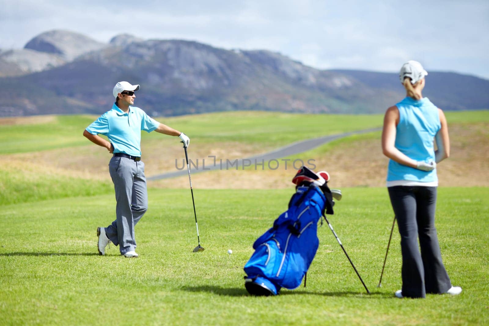 Couple, teamwork or golfer playing golf for fitness, workout or exercise together on green course field. Healthy people, woman golfing or athlete training in action or sports game driving with clubs.