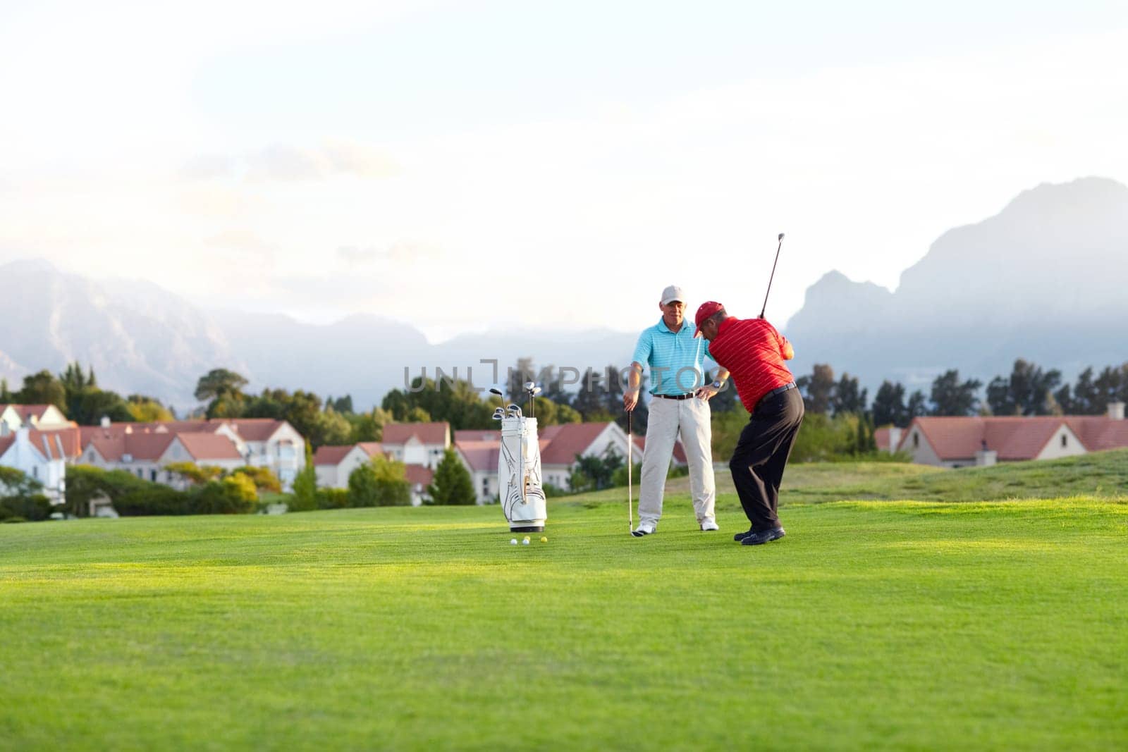 Golf course, stroke and training on the course, field or men in professional, golfer sports club and exercise on the grass. Friends, businessman or healthy game or competition on the green turf.
