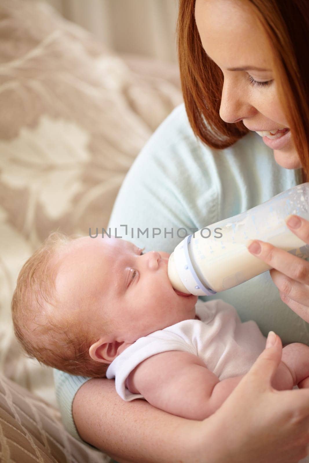 Mother, baby and feeding milk from bottle for nutrition, healthy breakfast and diet in the morning. Mom, child and feed newborn formula food for growth, development and wellness in happy home bedroom.
