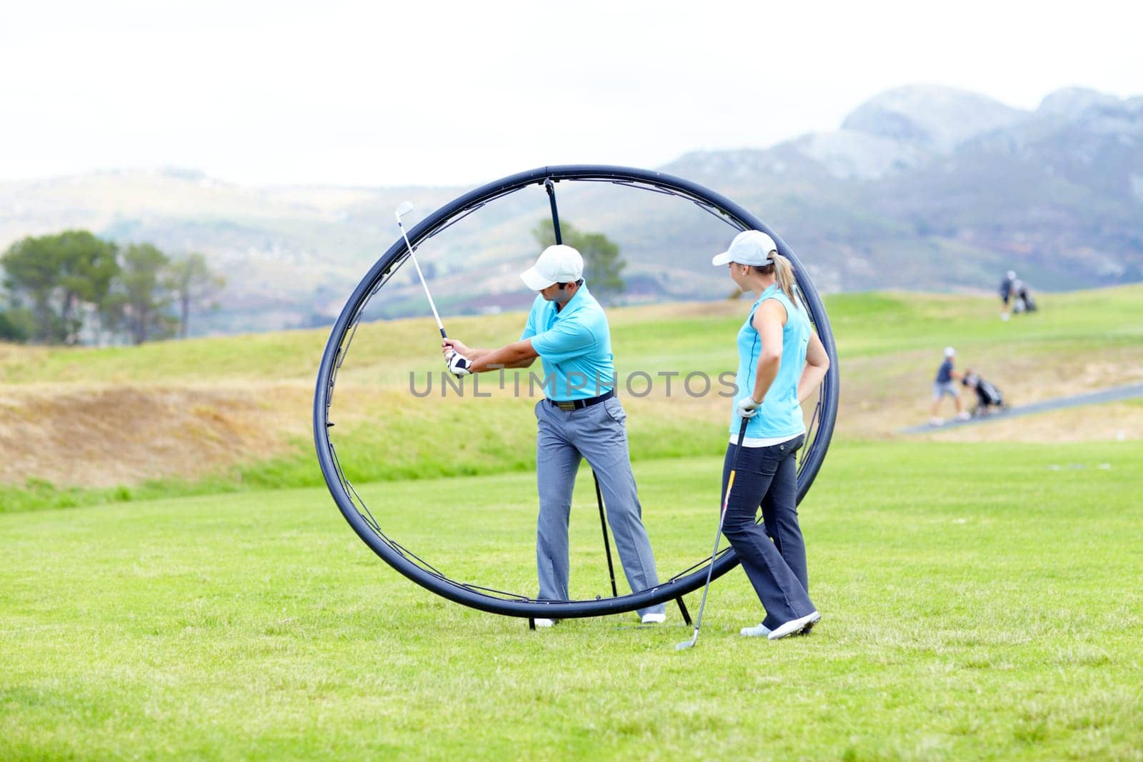 Ring, sports woman or golfer in golf course lesson for fitness, workout or exercise with a swing on field. Coaching, golfing game or athlete training with instructor for driving with a club stroke by YuriArcurs