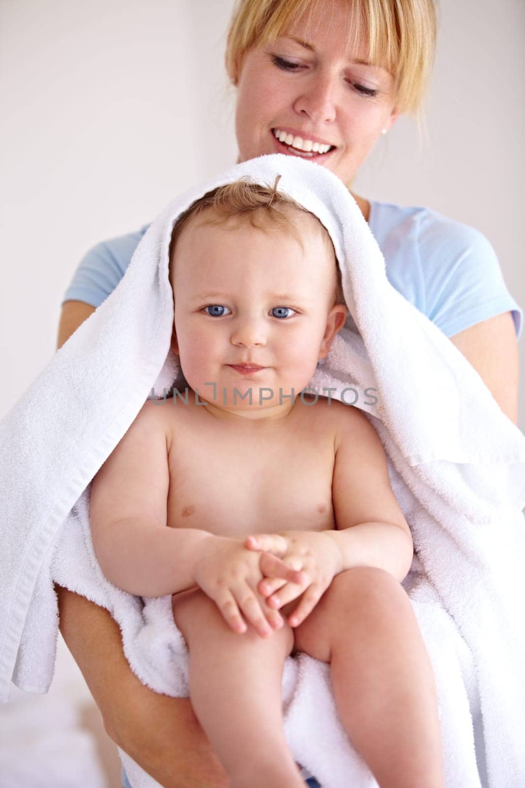 Baby, mom and hug for bath with care in a closeup for clean kid at home with love and caring. Towel, mother and infant with portrait to hold or hugs for care and love with kid in family home. by YuriArcurs